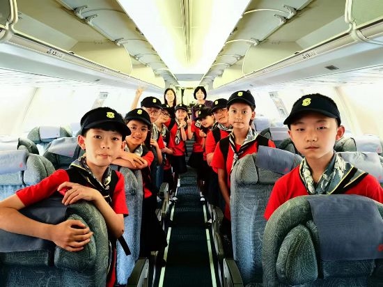 文縣東壩童聲合唱團(tuán)的孩子們?cè)陲w機(jī)上。
