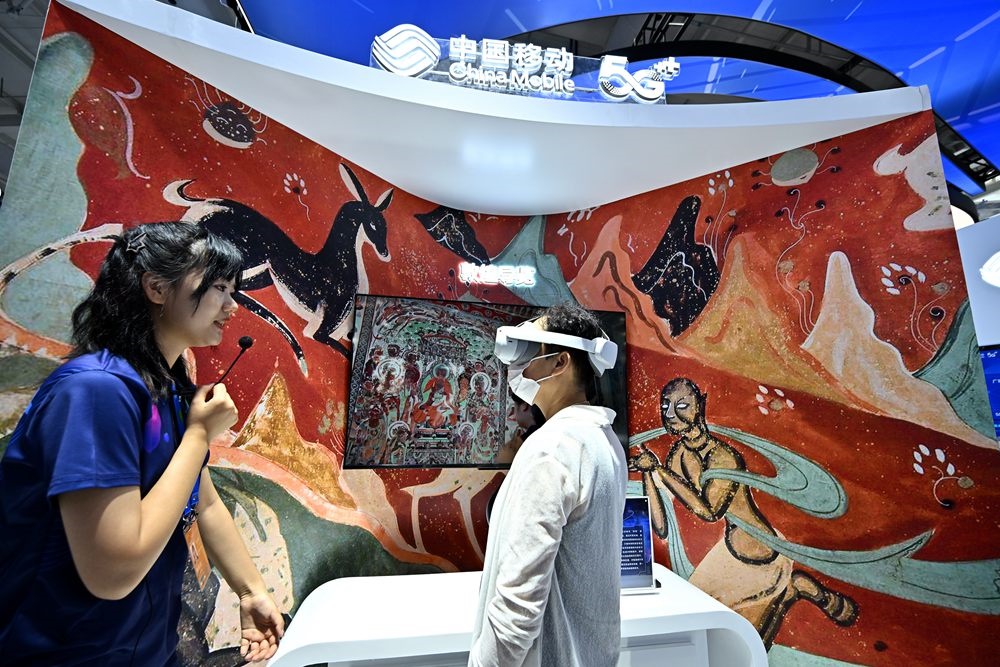 9月3日，一名參觀者在首鋼園中國移動(dòng)展臺(tái)體驗(yàn)基于AR/VR特效的敦煌導(dǎo)覽，沉浸式感受敦煌壁畫的魅力。新華社記者 李鑫 攝