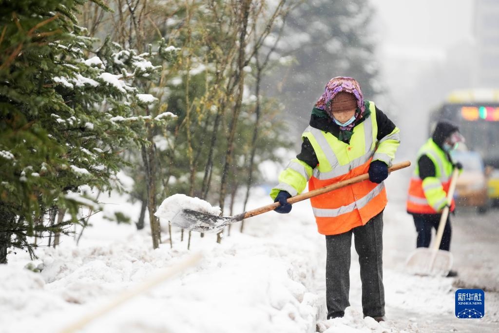 11月16日，環(huán)衛(wèi)工人在清理道路上的積雪。當日，黑龍江哈爾濱市迎來雨雪天氣。新華社記者 王建威 攝