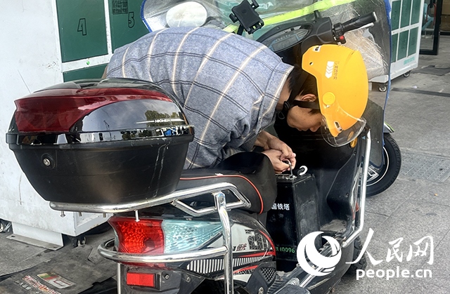 杭州一名外賣騎手正在更換共享電池。人民網(wǎng)記者 張麗瑋攝